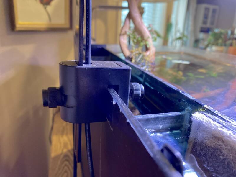 The mounting bracket of the Fluval Planted Aquarium Light on a rimless tank